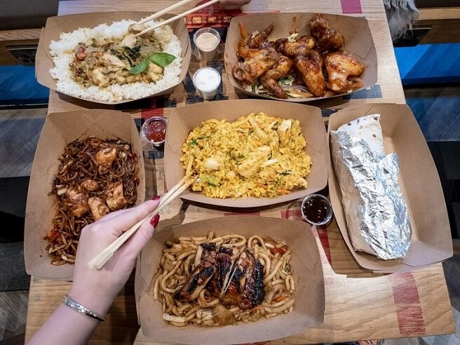 An array of dishes including a chargrilled wrap, Nasi Goreng, Chicken Teriyaki Noodles, Chicken wings and Thai Green Curry from Canaca World Street food restaurant in Newcastle Upon Tyne