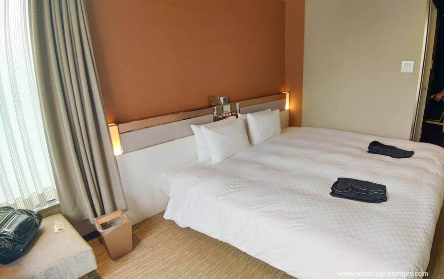 The incredibly spacious King Bed and soft pajamas are provided to use around Candeo Hotels Roppongi Tokyo| Read more at www.whatsupcourtney.com