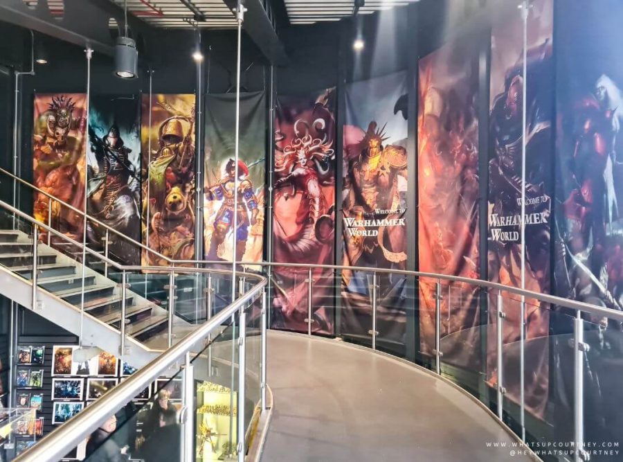 The upstairs of the Warhammer world reception area, with a wall lined with Warhammer posters