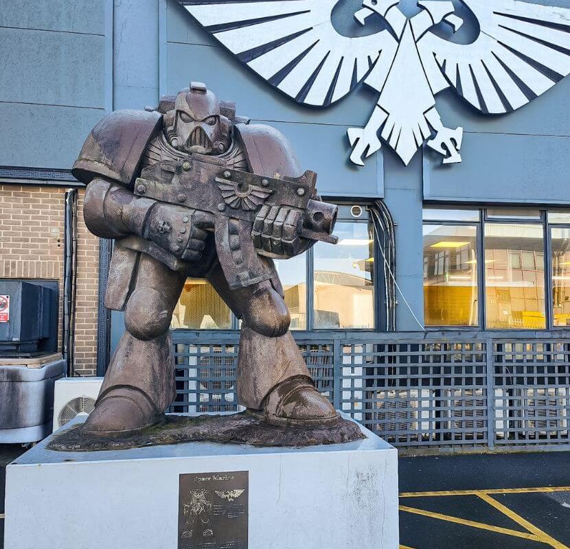 A statue of a space marine and logo of Warhammer outside of the Warhammer world in Nottingham