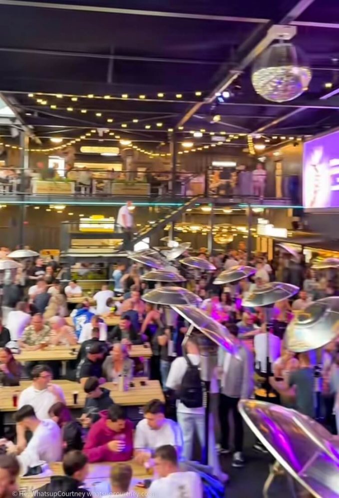 Inside of The Stack - shipping containers turned into a food court, bar and stage hosting events like karaoke nights and football match viewings.