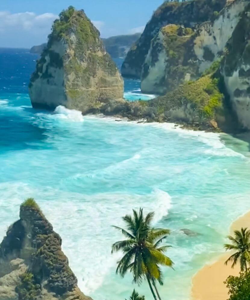Beach in Bali surrounded by rocks in Indonesia