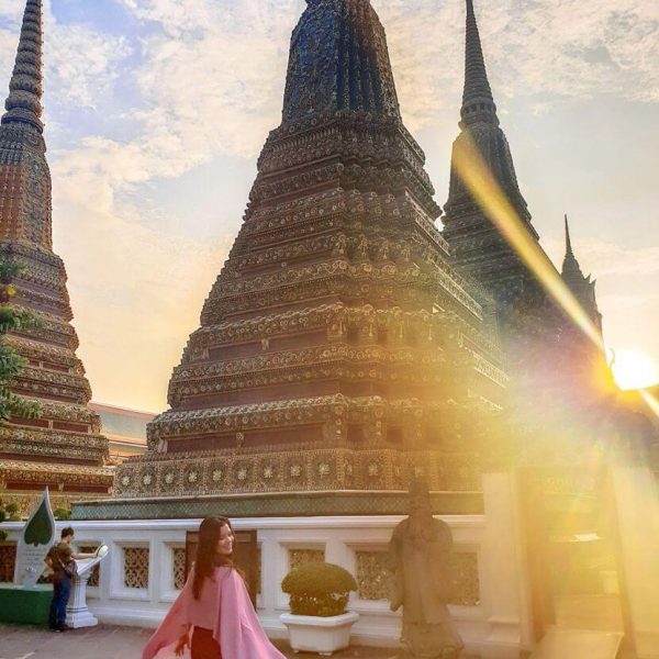 Temple at golden hour in Bangkok Thailand with Courtney from whatsupcourtney.com posing