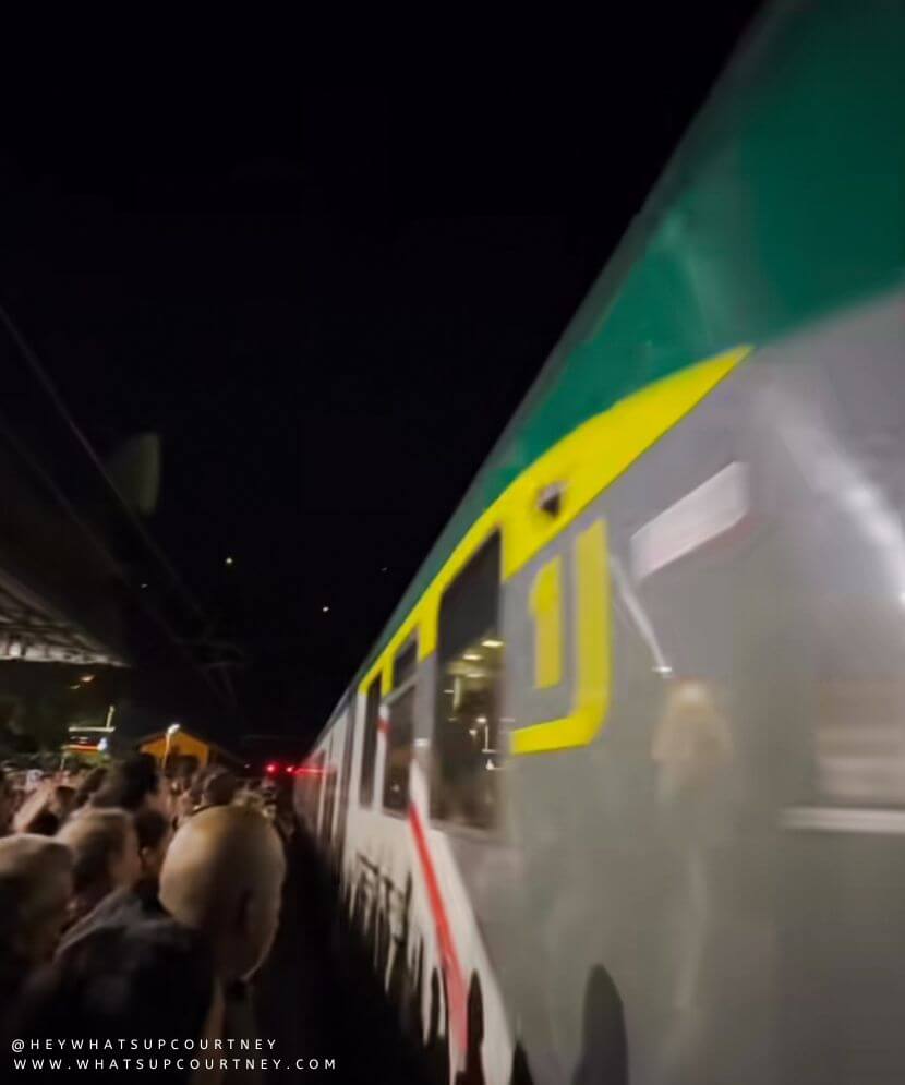 crowds of people waiting for the train at Varenna station in Lake como