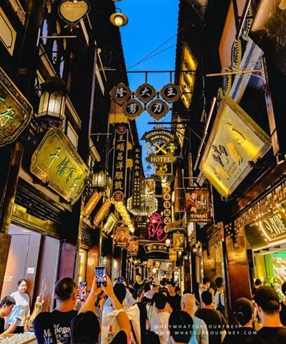 beautiful alleyway with lanterns at night inside the Yu Garden bazaar lined with shops