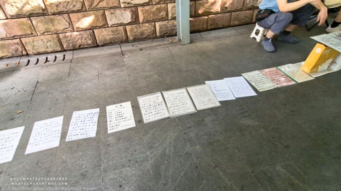 a stack of papers listing potential matches at the marriage sunday market in Shanghai
