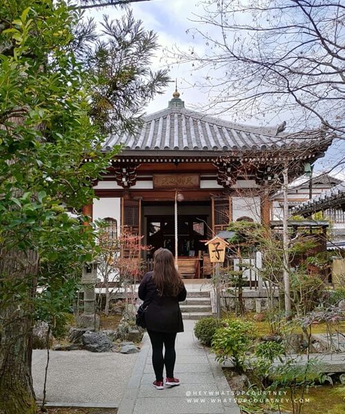 Japanese shrine in Kyoto Japan with Courtney from whatsupcourtney.com in front of the entrance