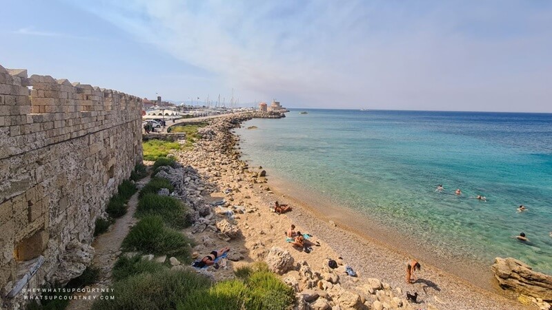 beach and sea by rhodes old town wall