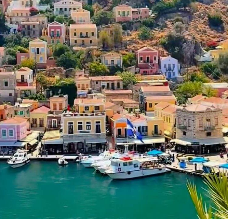 Symi harbour front with ferries and colourful houses